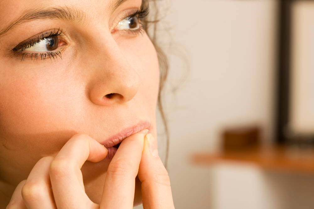 Brunette Woman Biting On Her Fingernails