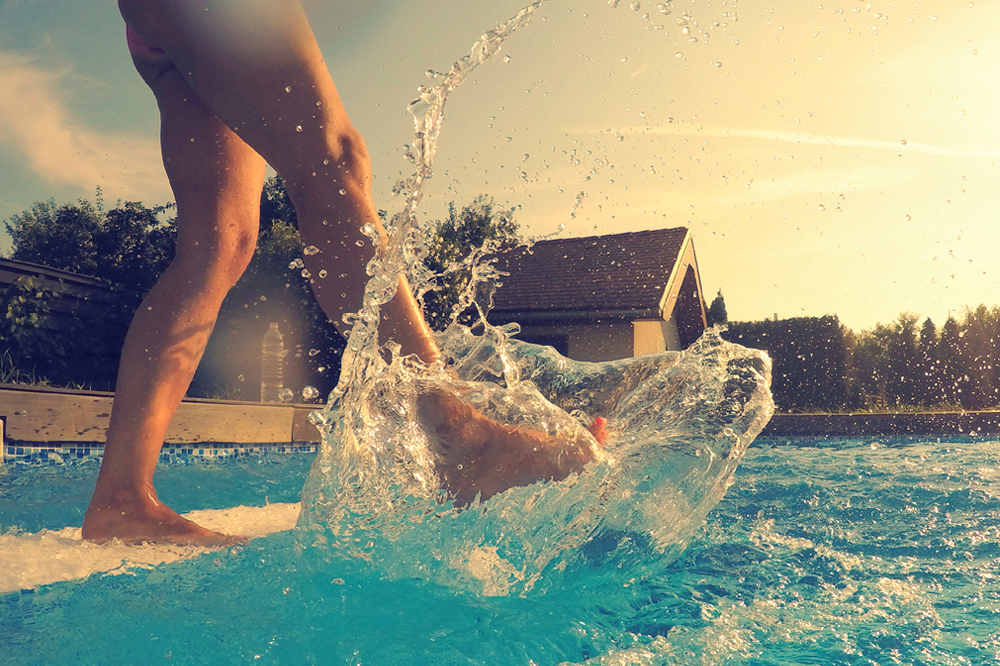 Woman Kicking Her Foot and Leg In Swimming Pool Water