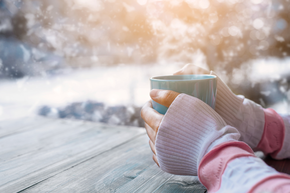 Cold Hands Holding A Warm Cup of Coffee