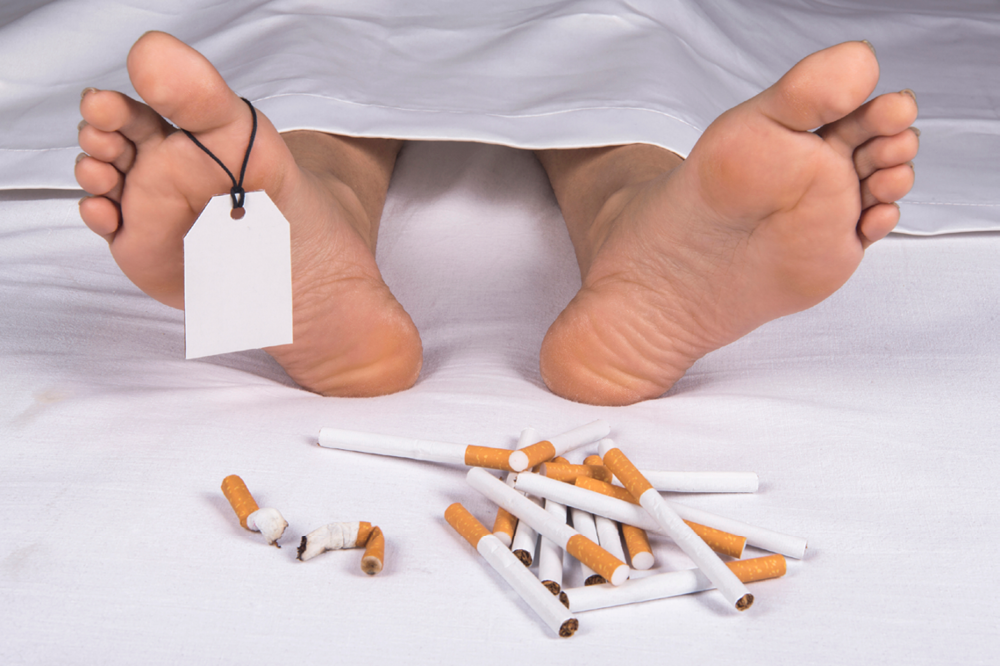The Feet Of A Corpse Next To A Pile Of Cigarettes